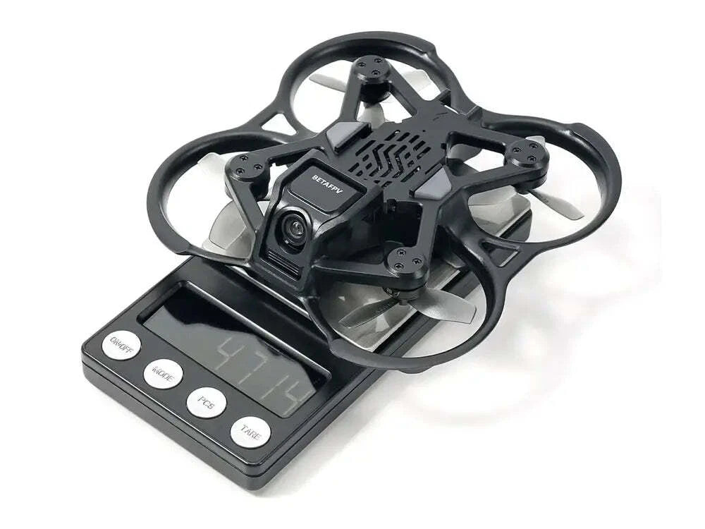 Black drone with camera on a digital scale against a white background