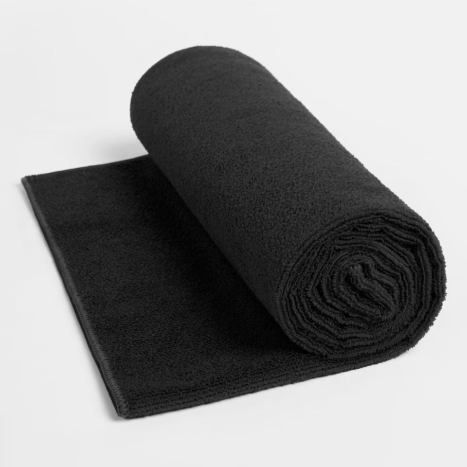 Rolled-up black towel on a white background