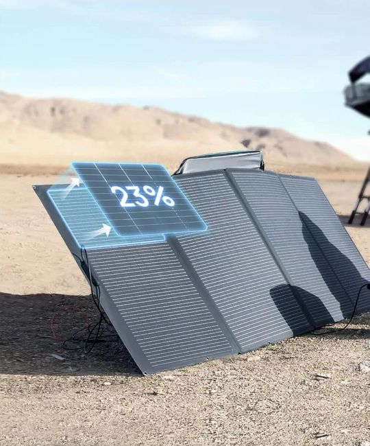 Foldable solar panel with a digital display showing 23% on a desert landscape.