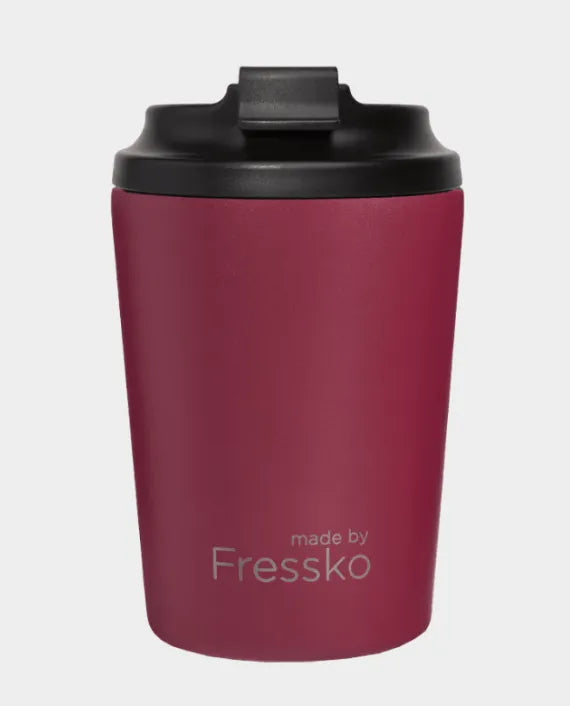 Red travel mug with black lid on a light gray background, featuring 'made by Fressko' branding.