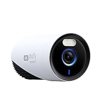 White security camera with black lens on a white background