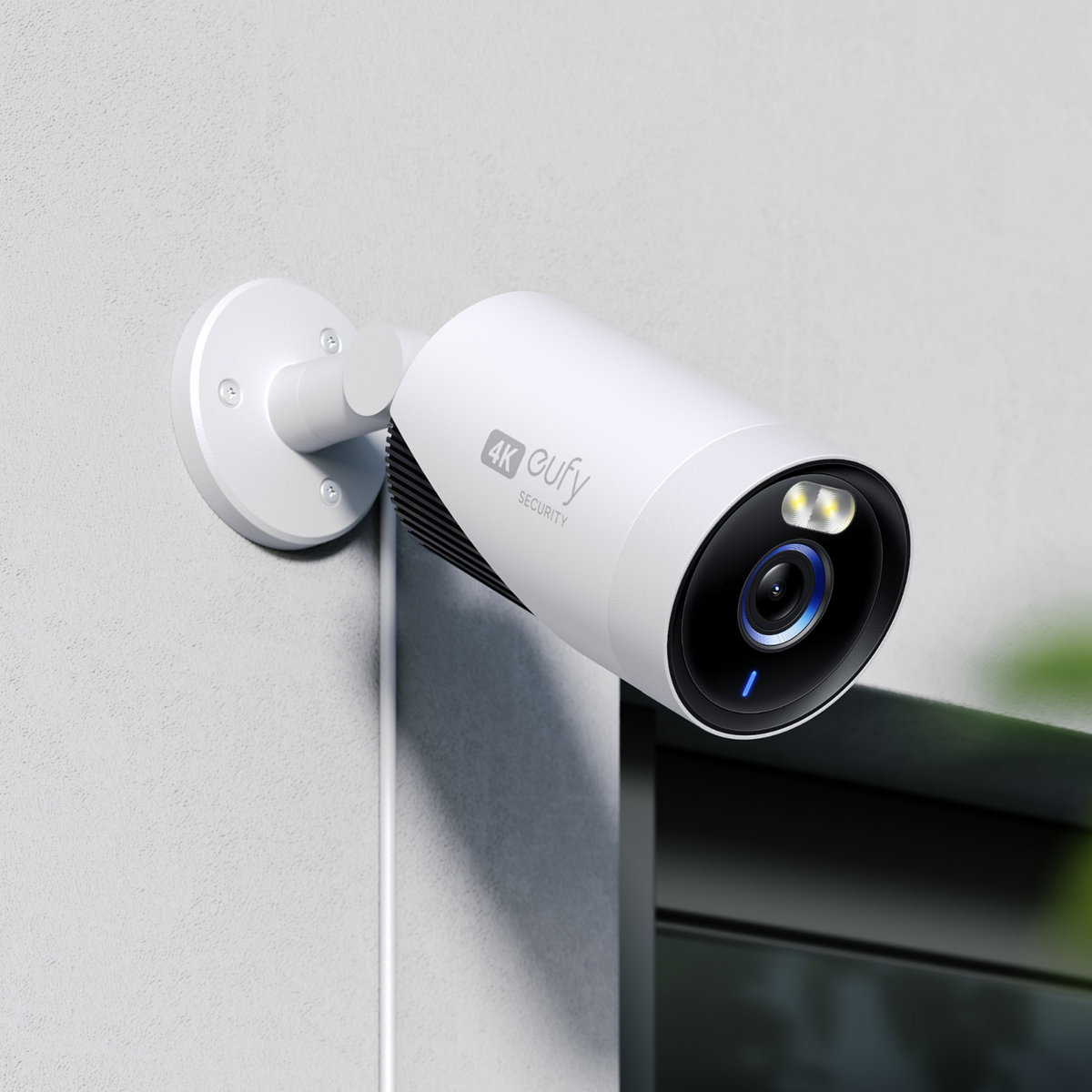 White security camera with '4K Eufy' branding on a light gray wall.