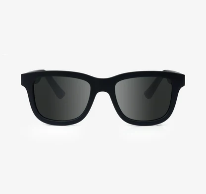 Black sunglasses with dark lenses on a light gray background