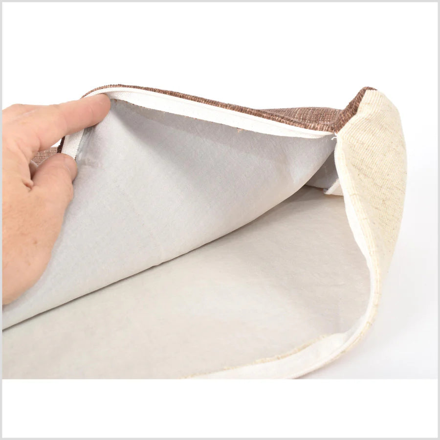 Person peeling back a layer of a textured surface with a spoon on a white background