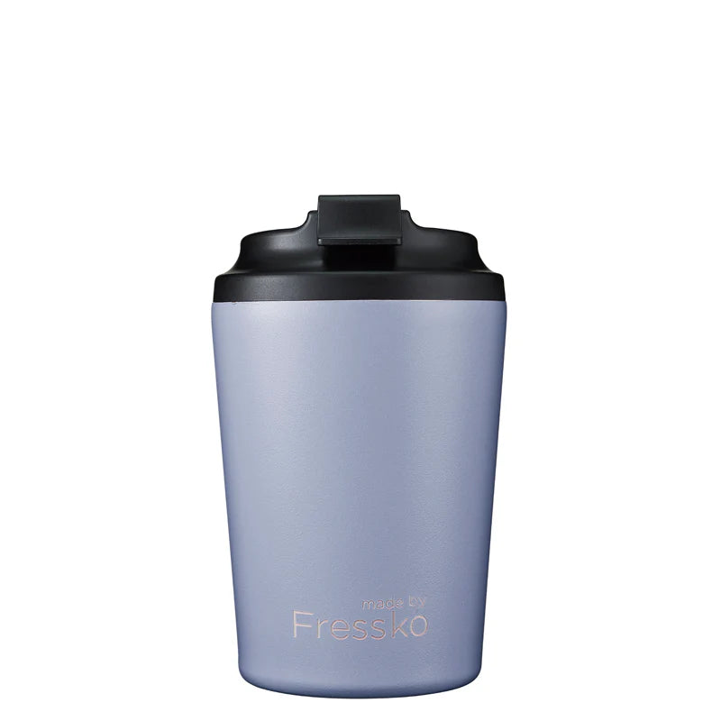 Purple tumbler with black lid on a white background