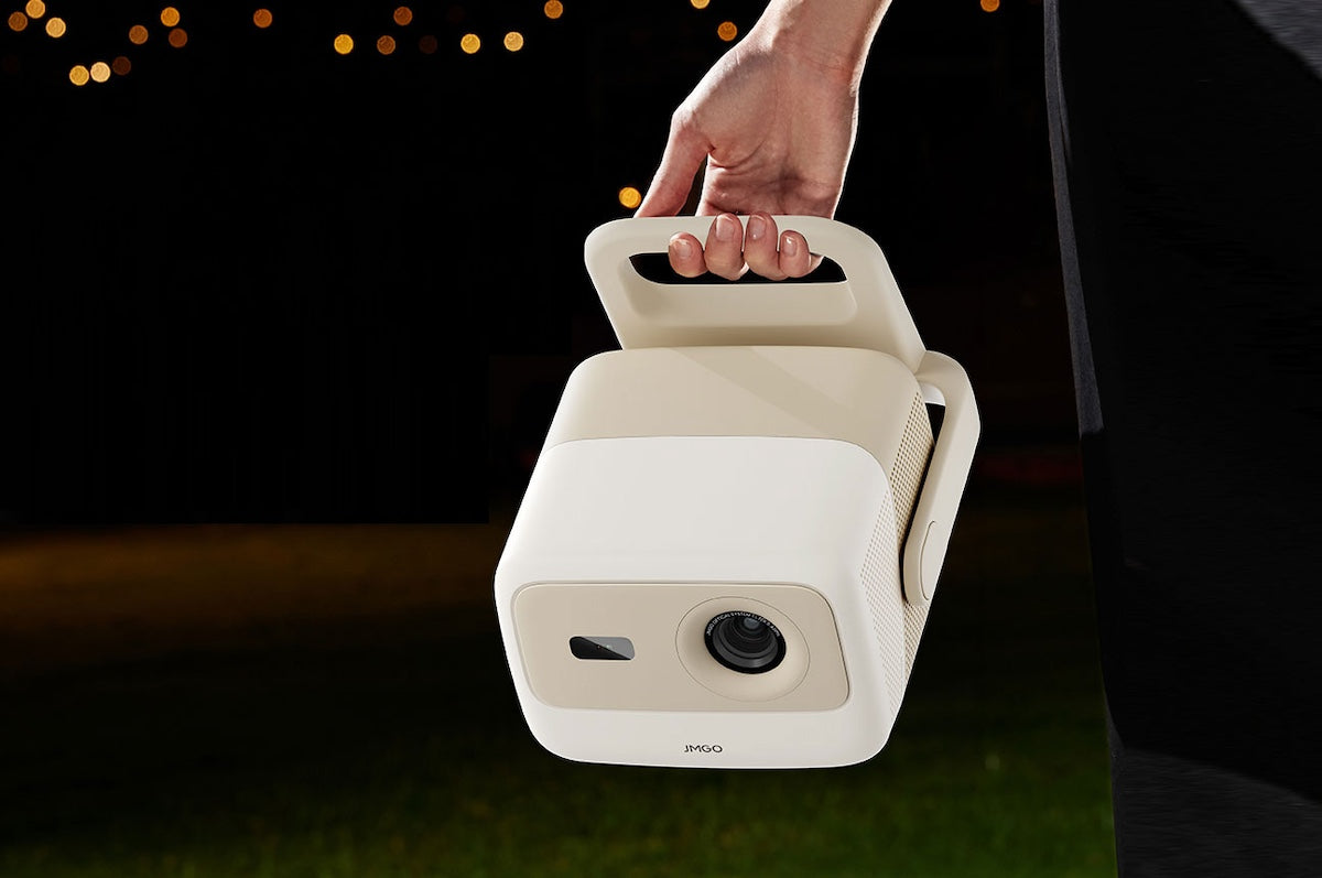 Hand holding a portable camera device with a dark background