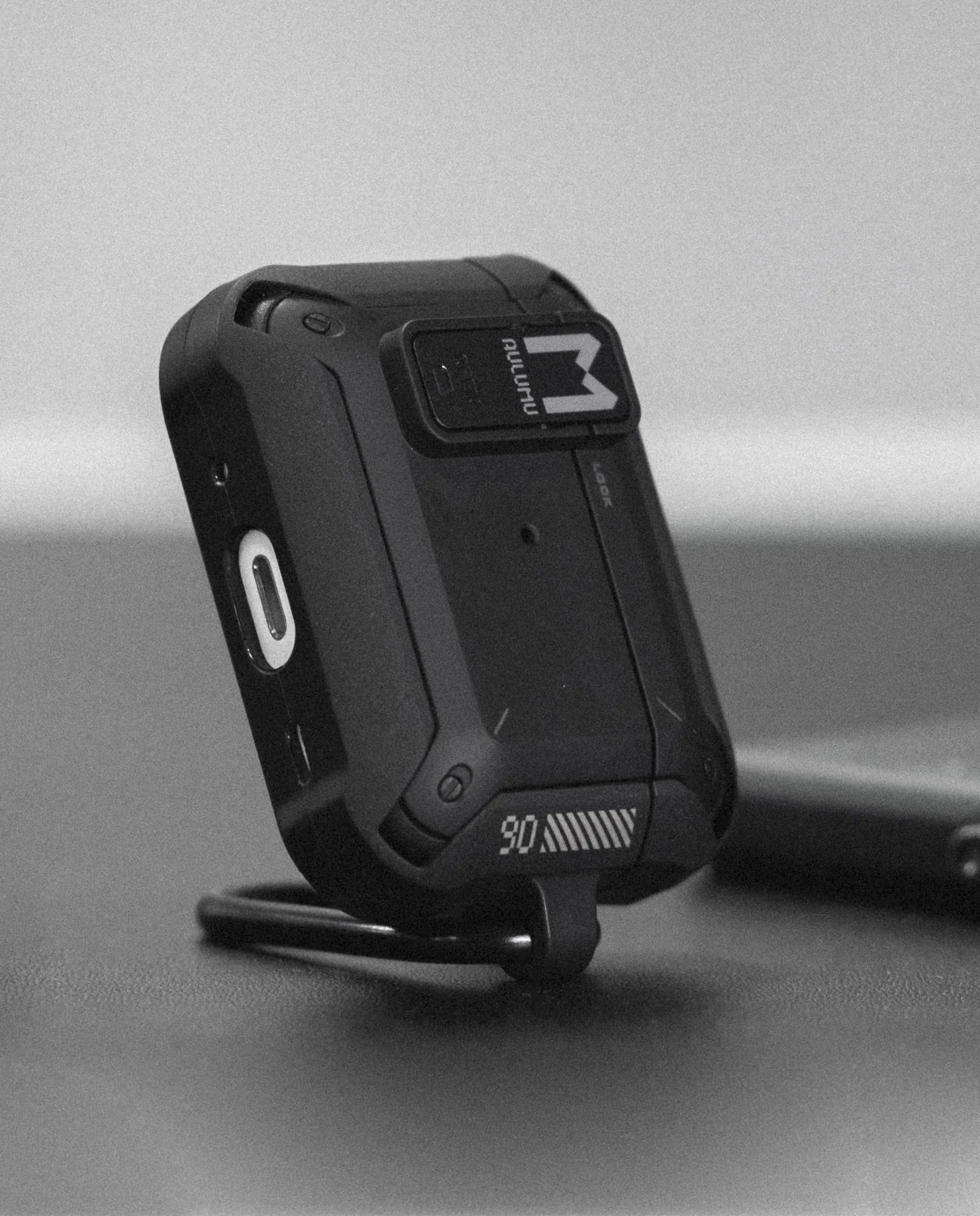 Black rugged device with a brand logo on a gray background