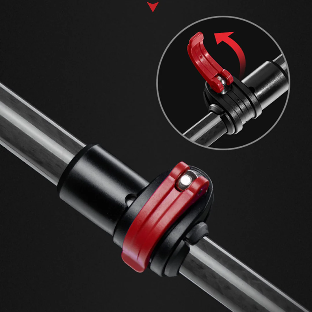 Close-up of a black and red bicycle seat post with a detailed view of the clamp mechanism on a dark background.