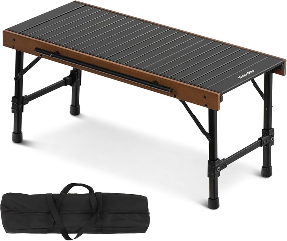 Foldable camping table with black top and brown sides, accompanied by a carrying bag on a white background.