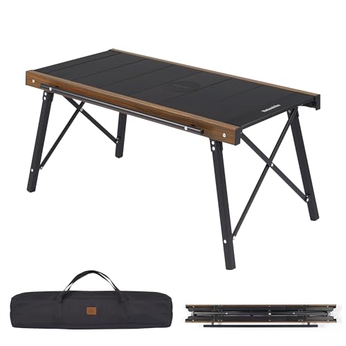 Folding camping table with black top and wooden sides, accompanied by a carrying bag and additional sections.