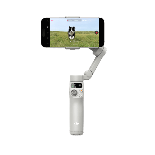 Handheld camera stabilizer with smartphone displaying a dog on grass