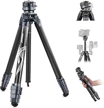Black camera tripod with additional attachments on a white background