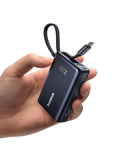 Hand holding a black USB-C power bank with a visible brand logo on a white background