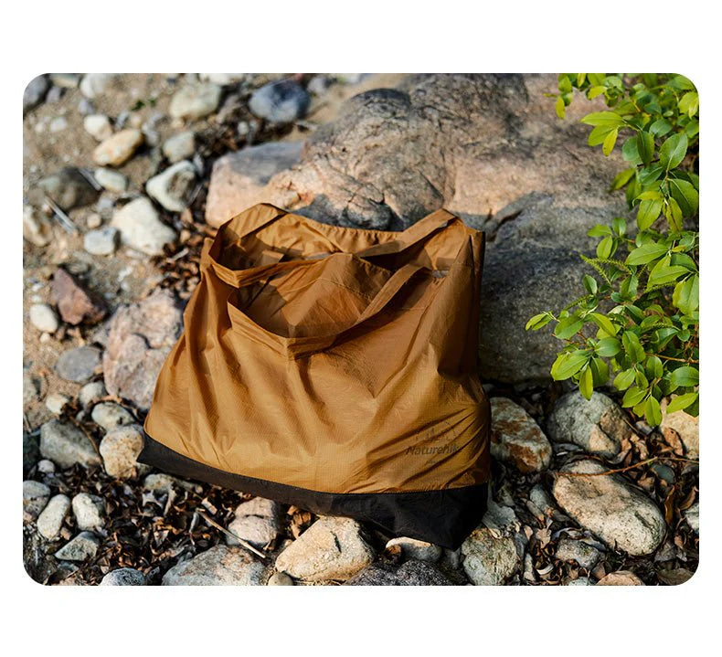 Brown bag on a rocky ground with greenery