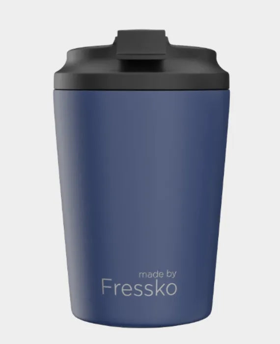 Blue tumbler with black lid on a light gray background, branded 'made by Fressko'.