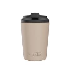 Beige tumbler with black lid on a white background