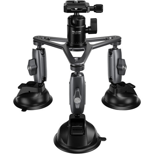 Black camera tripod with three suction cups on a white background