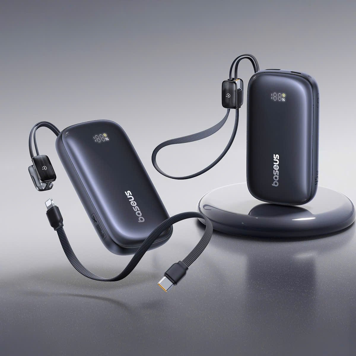 Two black electronic devices with cables on a gray background, featuring the brand 'Sesam'.