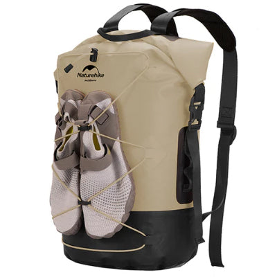 Beige and black backpack with a shoe compartment on a white background