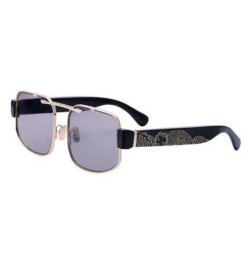 Sunglasses with gold frame and black arms on a white background