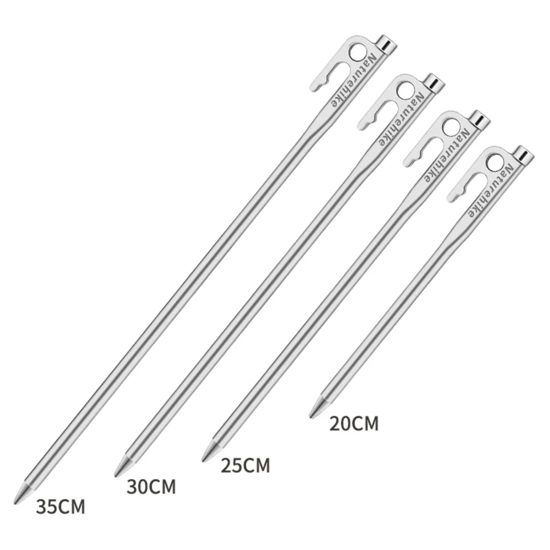 Set of metal tent stakes with varying lengths on a white background