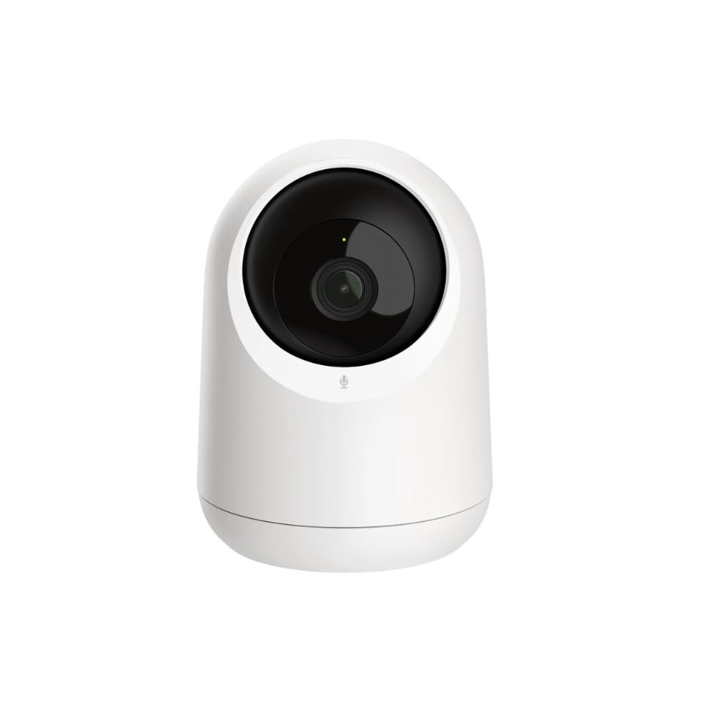White security camera with black lens on a white background